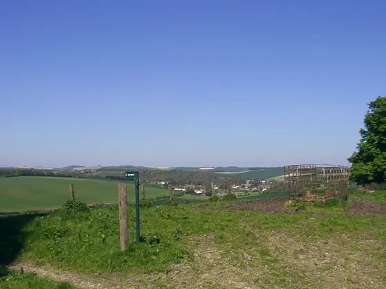 First view of Lambourn from a hill-top with very little parking space on a narrow, winding road.