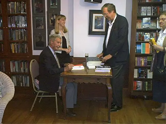 A fan is glad of the chance to talk with Dick Francis while his book is signed.